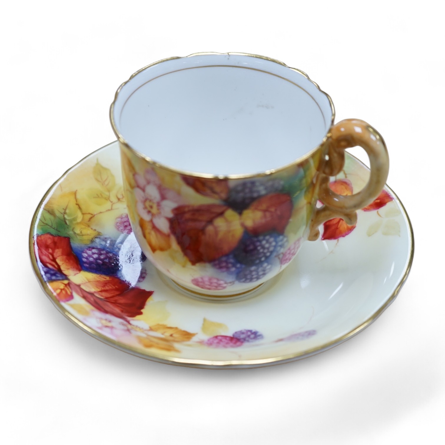 A Royal Worcester fruit painted cup and saucer by Kitty Blake, saucer 11.5cm diameter. Condition - good